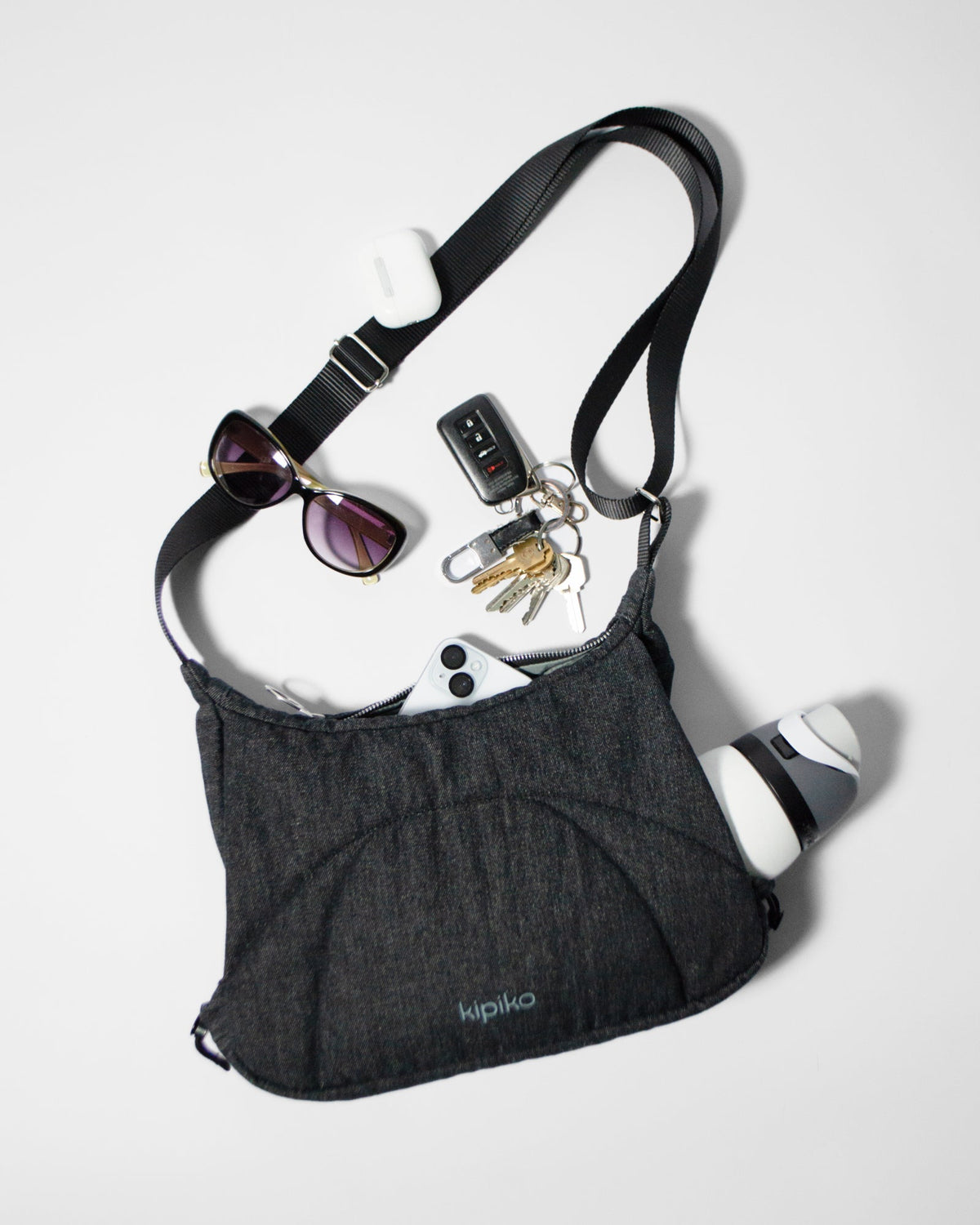 Bottle Bag in Black Denim / Dusty Blue, contents spilled out
