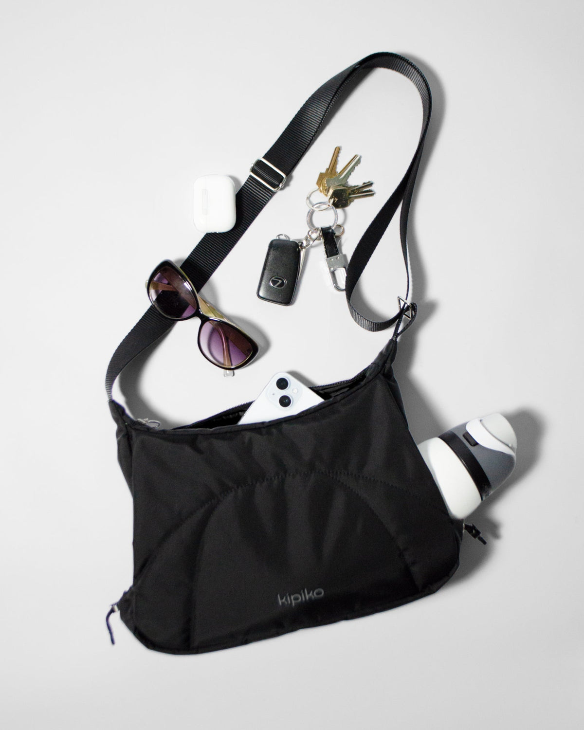 Bottle Bag in Black Crinkle Nylon / Black, contents spilled out